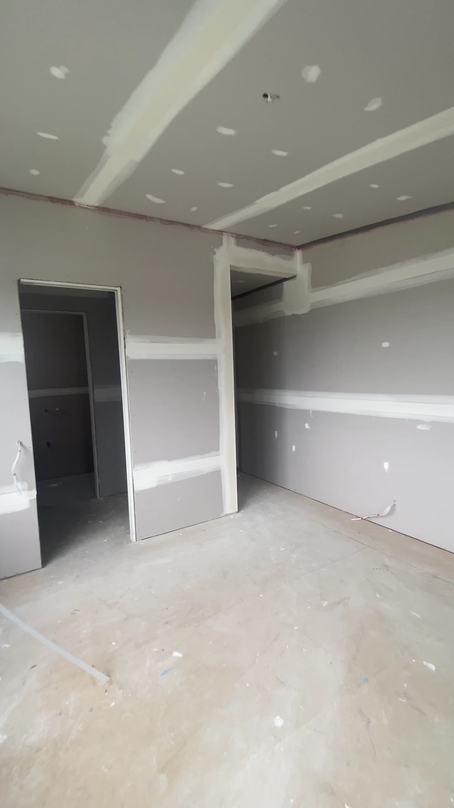 Freshly sheeted and set room with doorways leading off it