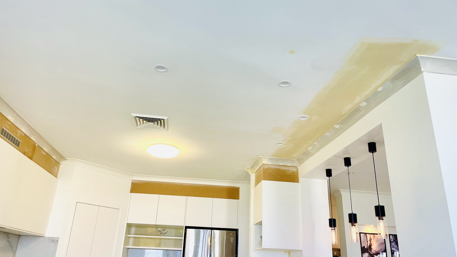 Kitchen ceiling being repaired in a lived-in home